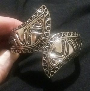 Silver tone hinged bangle.